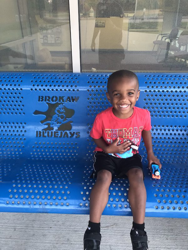 child sitting on bench