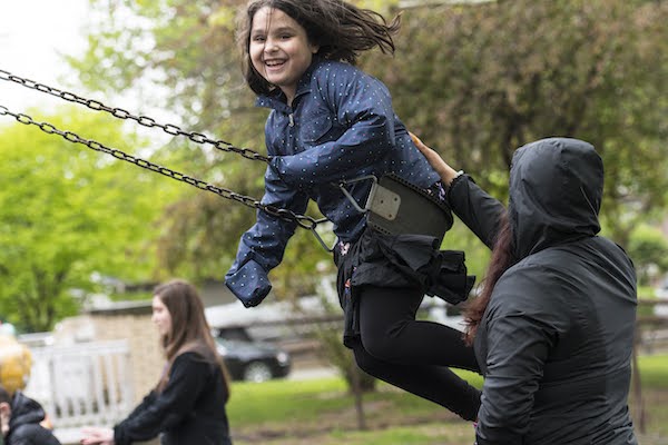 girl on swing set smiling